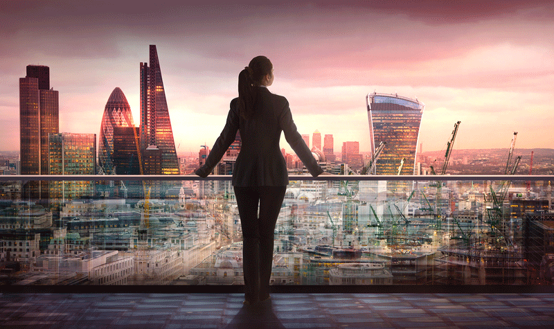 A woman in a suit stands looking out over a city skyline. This could represent career fulfillment that an Ontario therapist can help you realize through online therapy in Ontario. Learn more about finding self fulfillment in Ontario, CA and how an Ontario, Canada therapist today.